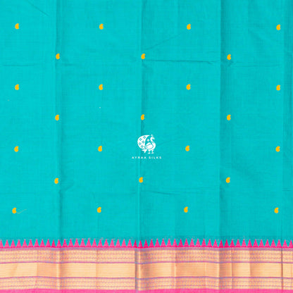 Yellow thread buttas across the teal green body, meeting the pink zari temple border