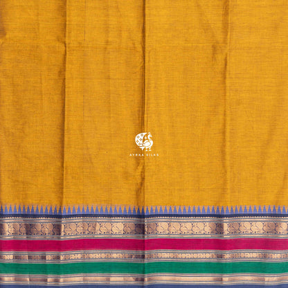 Plain mustard cotton body meeting the blue temple kumbam border
