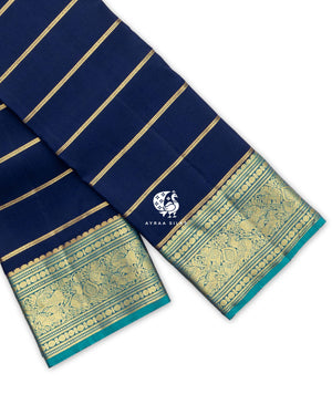 Navy blue Kanchipuram pattu saree with zari stripes and a teal zari border of Yaanai (elephant), Mayil (peacock) and manga motifs