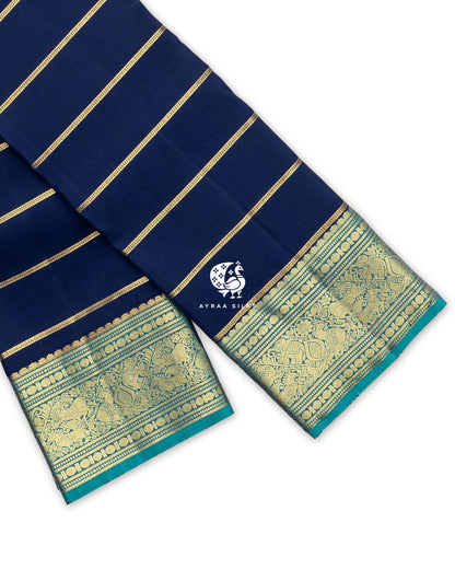 Navy blue Kanchipuram pattu saree with zari stripes and a teal zari border of Yaanai (elephant), Mayil (peacock) and manga motifs