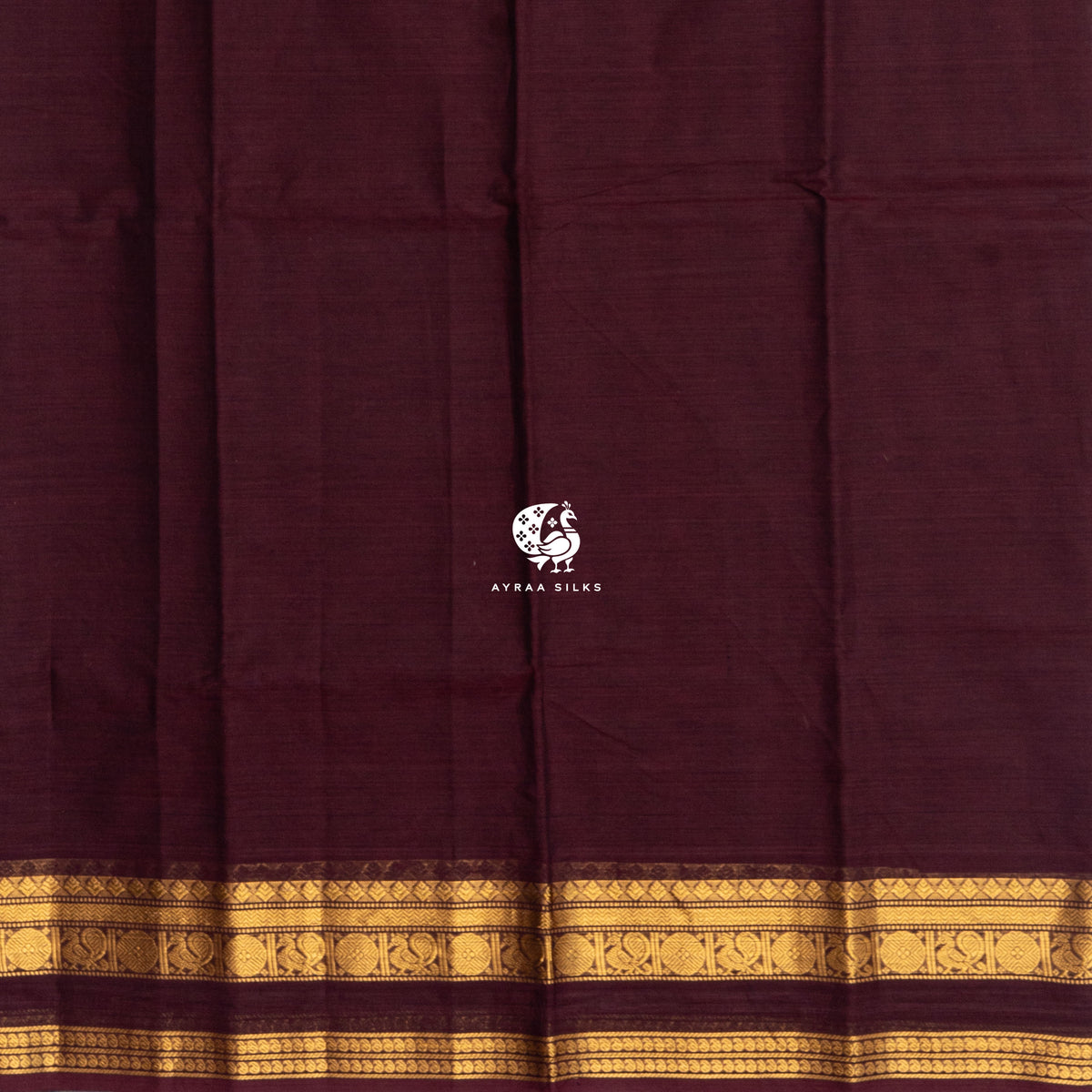 Plain maroon cotton body meeting the self colour gold zari border