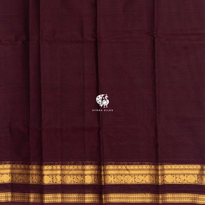 Plain maroon cotton body meeting the self colour gold zari border