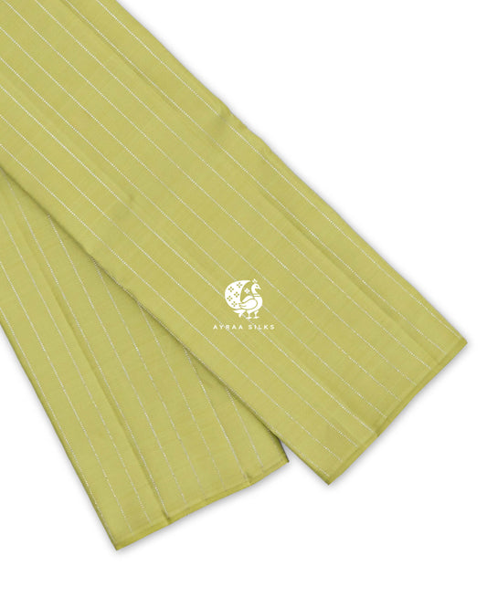 Pista Green Zari Vari Kanchipuram silk saree folded, showing the borderless edge with fine silver zari lines