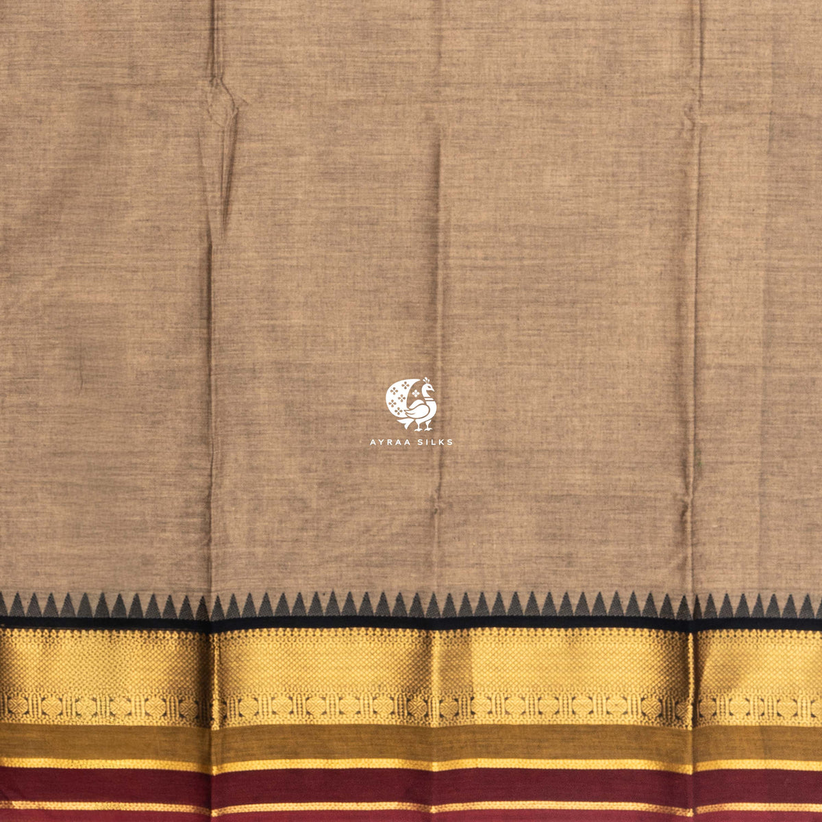 Plain beige cotton body meeting the black temple kumbam border in zari