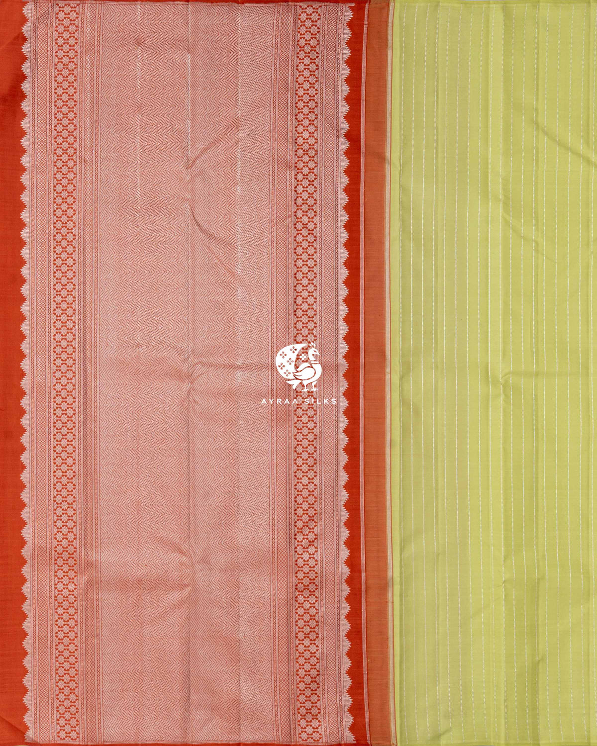 Contrast rust orange pallu in silver zari chevron weave with floral side borders beside the pista green striped body