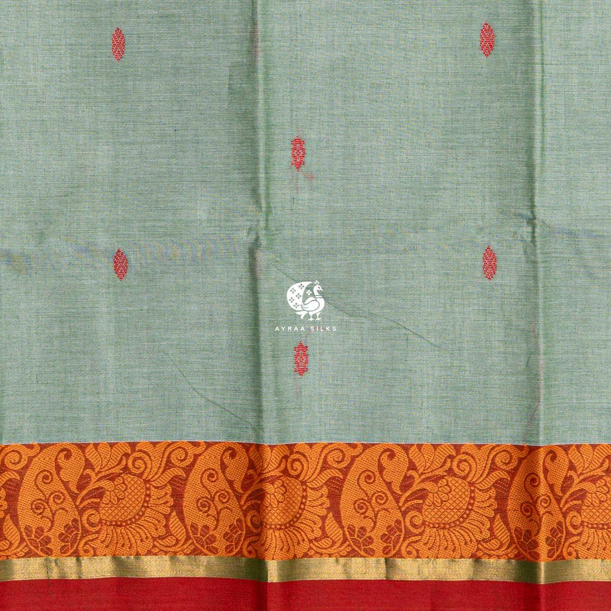 Close view of the red buttas woven into the sage green cotton