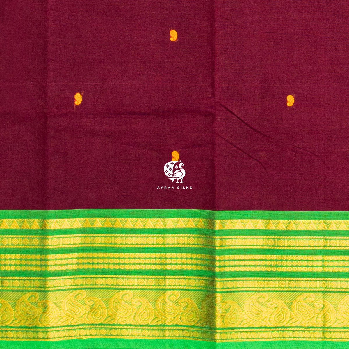 Close view of the mustard buttas woven into the maroon cotton