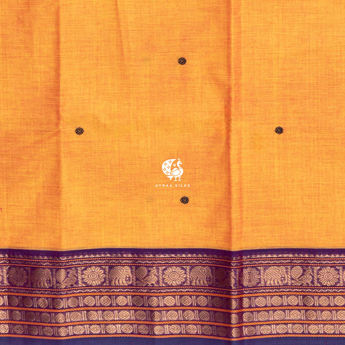 Close up of purple round buttas woven across the mustard cotton body above the purple border