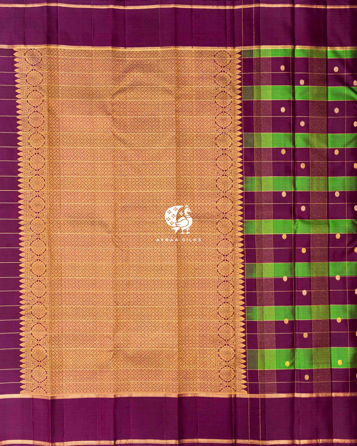 Gold zari pallu in a diamond lattice pattern with floral zari side borders on a wine and green checked Kanchipuram silk saree