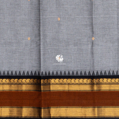 Close view of the gold zari buttas woven into the grey Kanchi cotton body