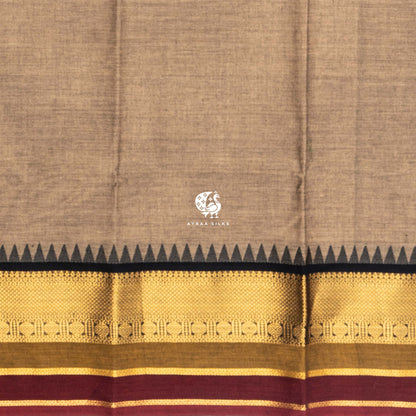 Close view of the running blouse and zari border with geometric bands, black temple points and maroon edge