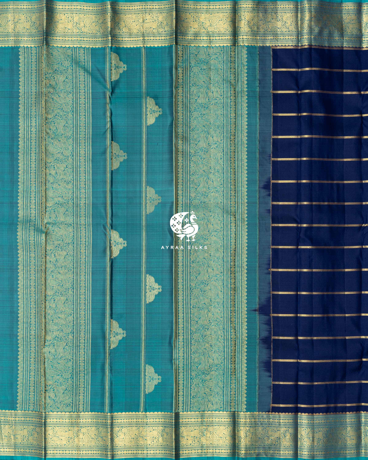 Contrast teal pallu with broad zari bands and zari buttas beside the navy blue zari-striped body of a Kanchipuram silk saree