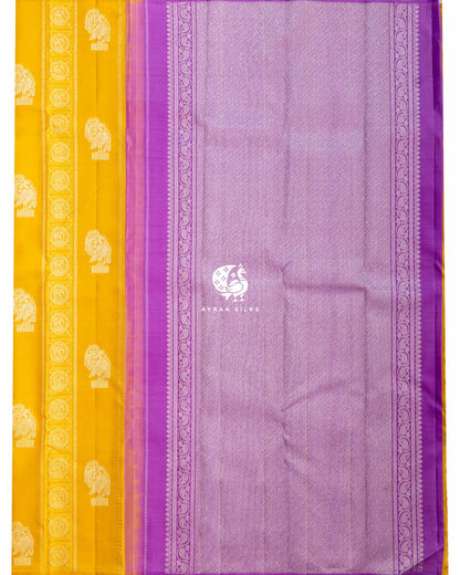 Contrast lavender silver zari pallu with purple paisley vine borders beside the mustard Annam and elephant body
