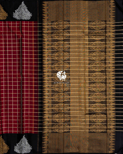 Black pallu with zari medallions, multicolour threadwork and zari stripes beside the maroon checked body