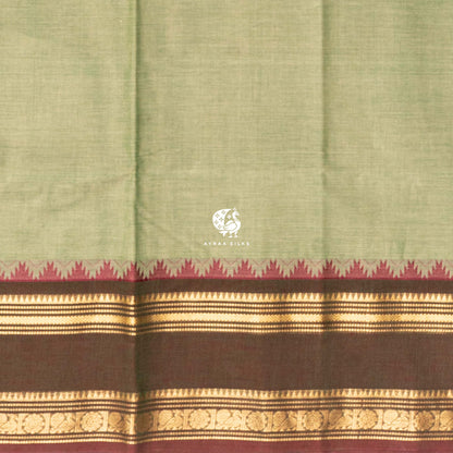 Close view of the running blouse and brown and gold zari border with floral roundels and maroon temple points