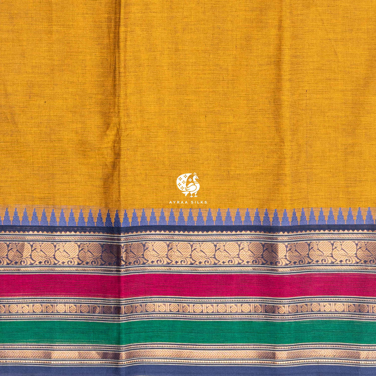 Close view of the running blouse and blue petta with peacock and paisley zari above the pink and green pettas