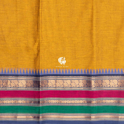 Close view of the running blouse and blue petta with peacock and paisley zari above the pink and green pettas