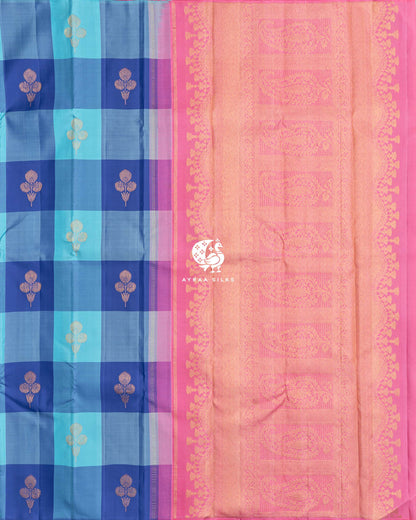 Contrast pink zari pallu with large manga (paisley) panels beside the blue checked body of the Kanchipuram silk saree