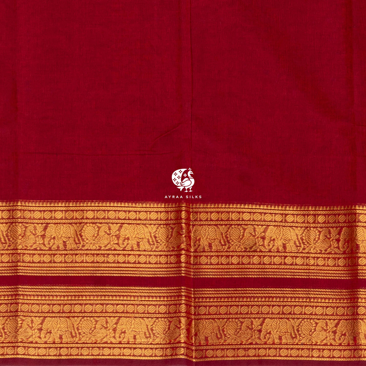Close view of the running blouse and gold zari border with rows of elephants and peacocks on red