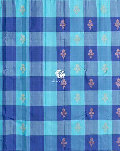 Full body view of the blue Kattam Kanchipuram silk saree with floral zari buttas across the checks
