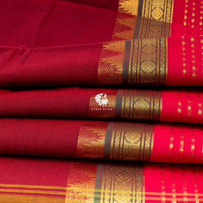 Folded maroon cotton saree showing the green and pink border repeating along the pleat edge