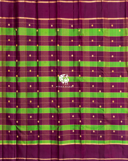 Full body view of wine Kanchipuram silk saree with green Kattam (checks), round zari buttas and wine borders