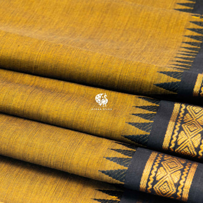 Close view of the running blouse and black zari border with geometric diamonds on mustard
