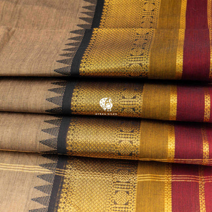 Folded stack showing the temple points where the black zari border meets the beige body