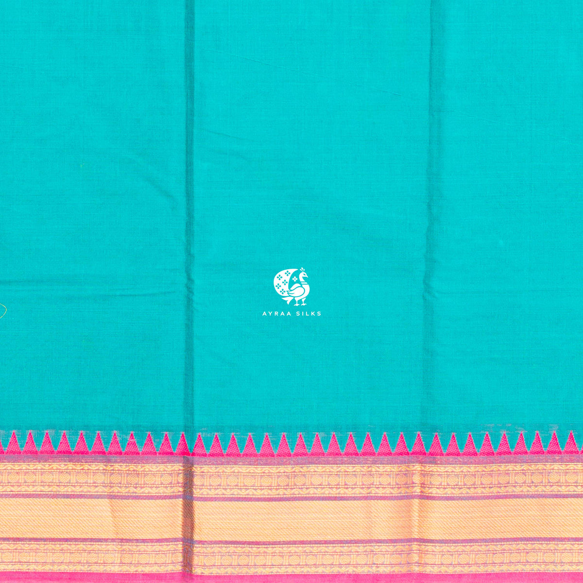 Close view of the running blouse and temple kumbam border in gold zari with a green band and pink outer edge
