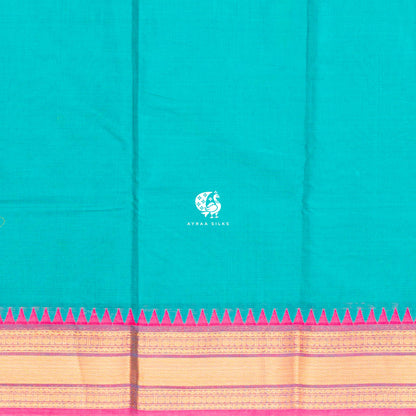 Close view of the running blouse and temple kumbam border in gold zari with a green band and pink outer edge