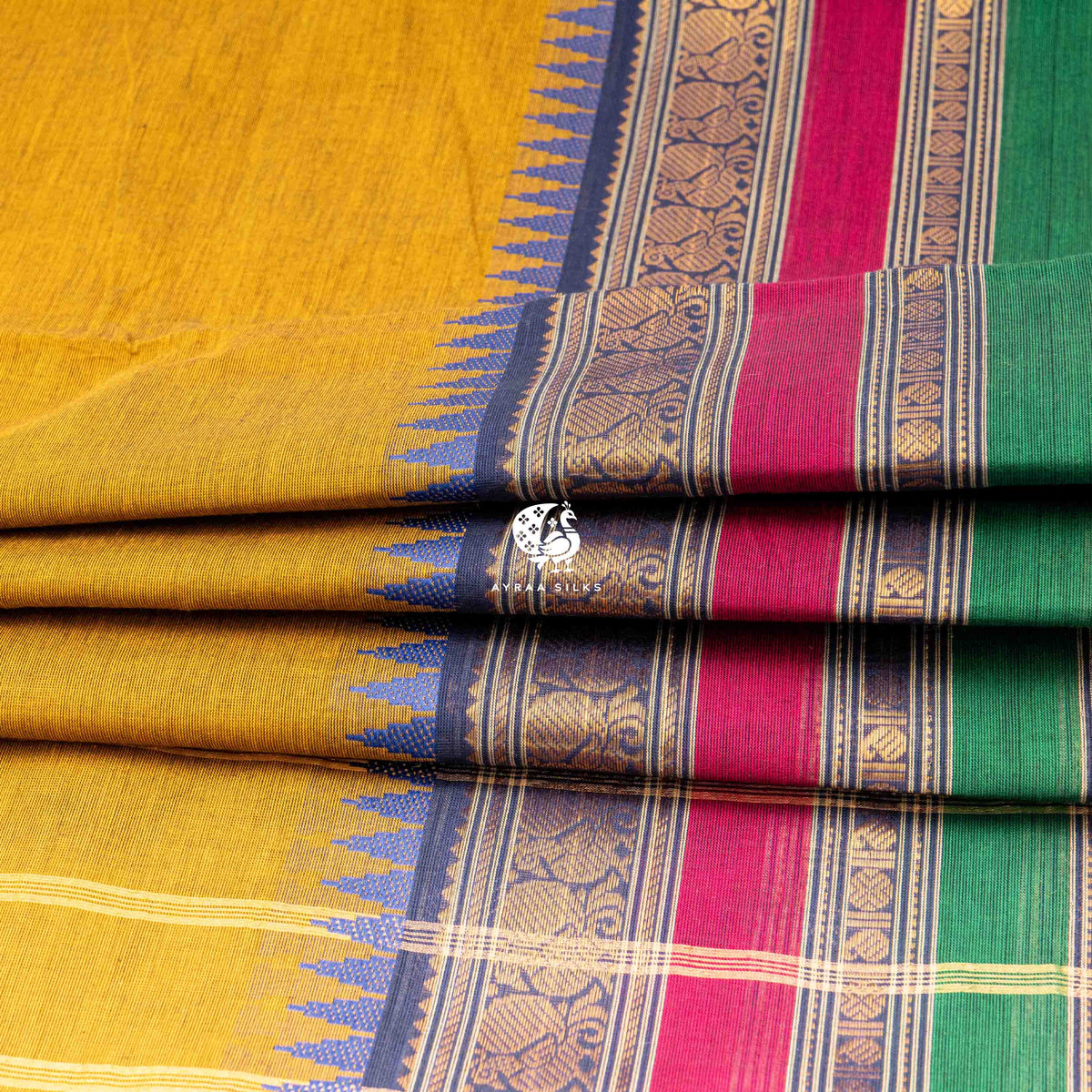 Folded stack showing the three pettas of the border in blue, pink and green
