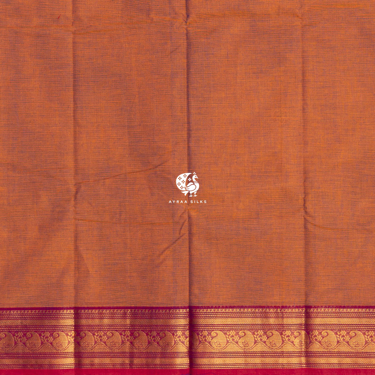Running blouse in the same rust as the body, with the same magenta zari border