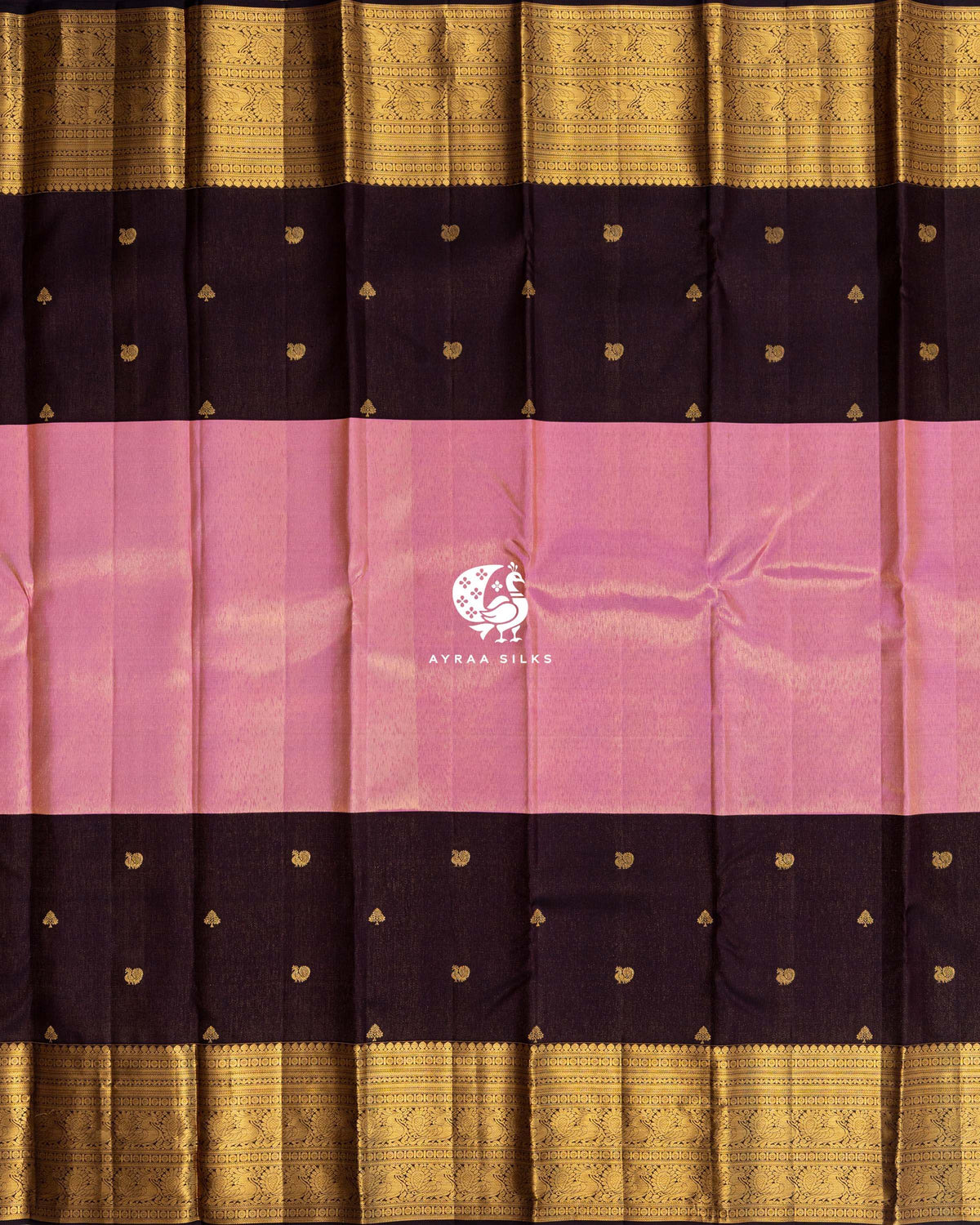 Full body view of coffee brown Kanchipuram silk saree with a broad rose pink zari band, peacock and tree zari buttas and gold zari borders