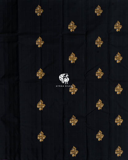 Full body view of the black Kanchipuram silk saree with rows of gold and silver zari floral buttas