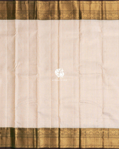 Full body view of the cream Kanchipuram silk saree with Manga zari brocade between wide antique gold zari borders