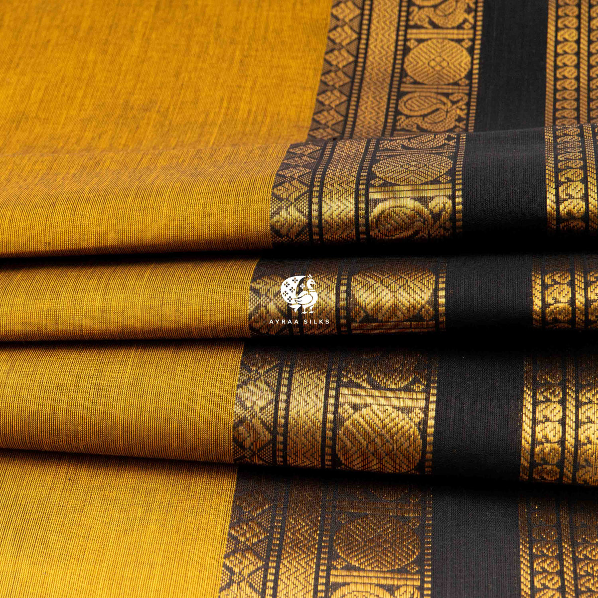 Folded stack showing the mayil roundels along the black zari border