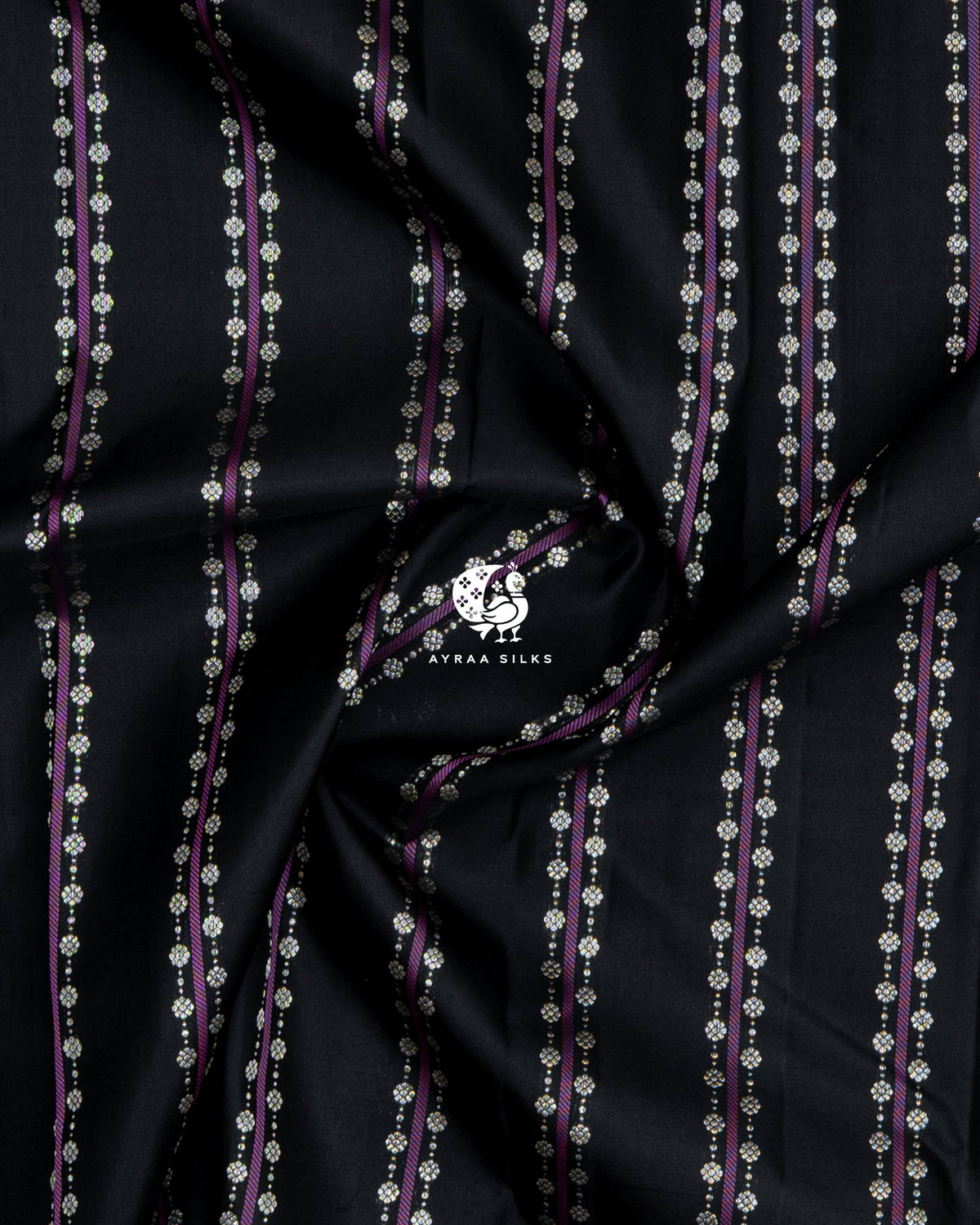 Close-up of the saree body, black silk gathered in soft folds with purple stripes and floral zari buttas