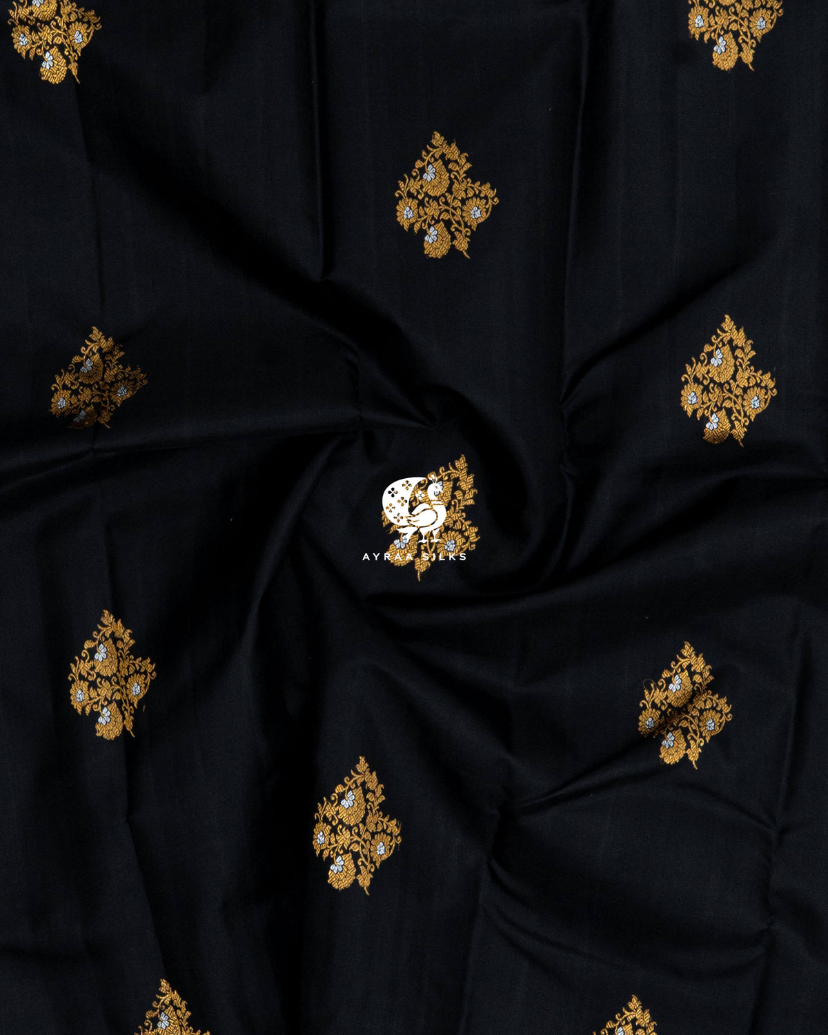 Close-up of the saree body, black pure Kanchipuram silk with gold zari floral buttas gathered in soft folds