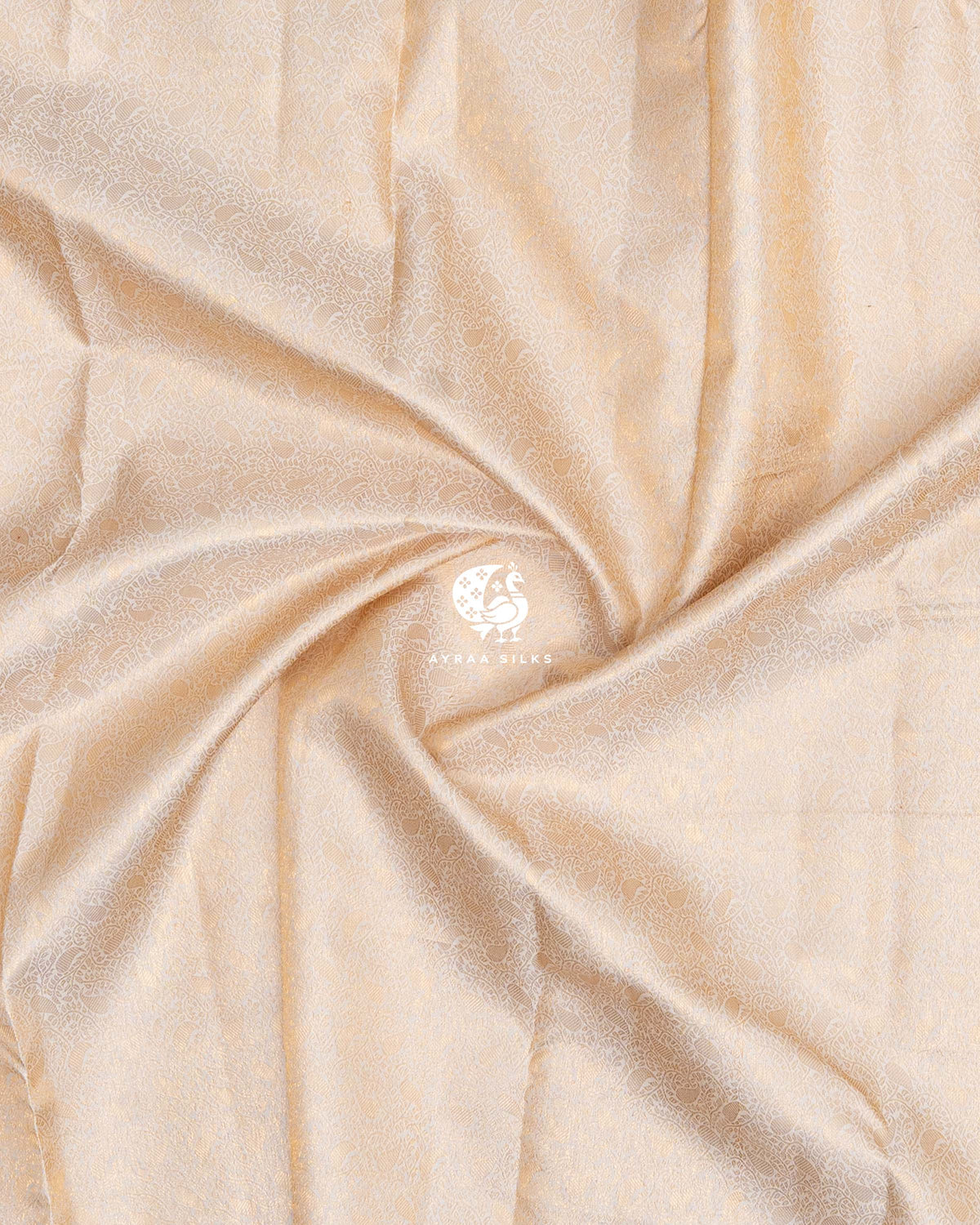 Close-up of the saree body, cream zari Manga brocade gathered in soft folds of pure Kanchipuram silk