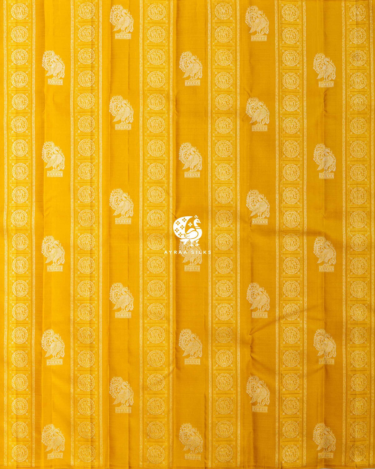 Full body view of the mustard yellow Kanchipuram silk saree with vertical Yanai zari bands and rows of Annam buttas