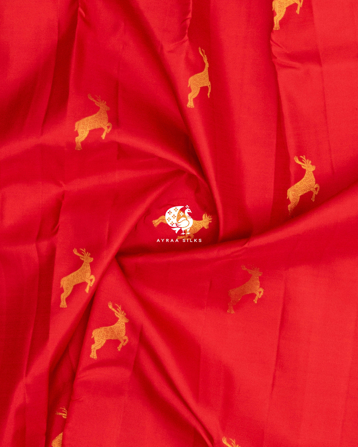Close-up of the saree body, red pure Kanchipuram silk with leaping deer zari buttas gathered in soft folds