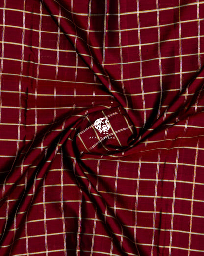 Close-up of the saree body, maroon pure Kanchipuram silk with zari Kattam (checks) gathered in soft folds