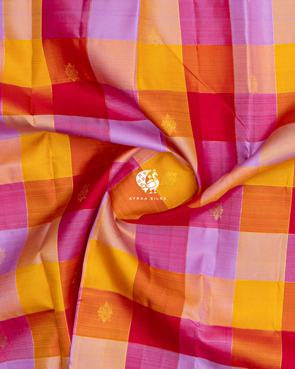 Close-up of the saree body, multicolour Kattam (checks) with kolam zari buttas gathered in soft folds of pure Kanchipuram silk