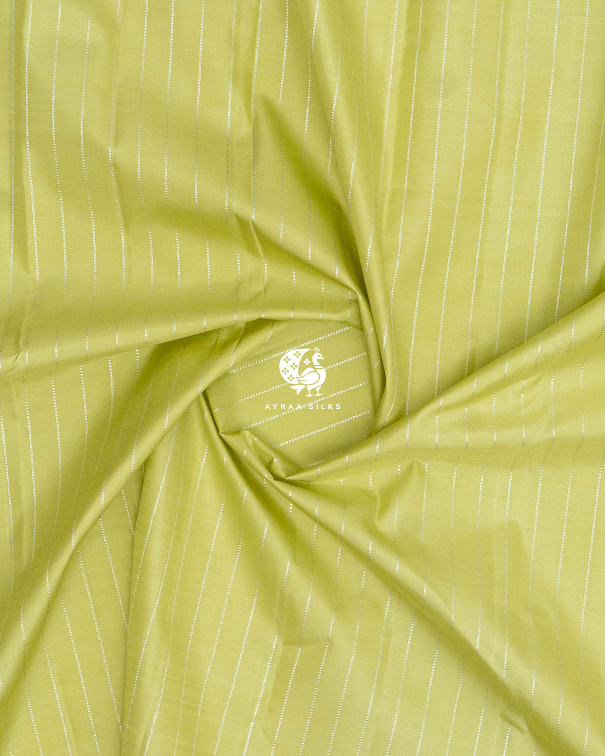 Close-up of the saree body, pista green silk with silver zari lines gathered in soft folds