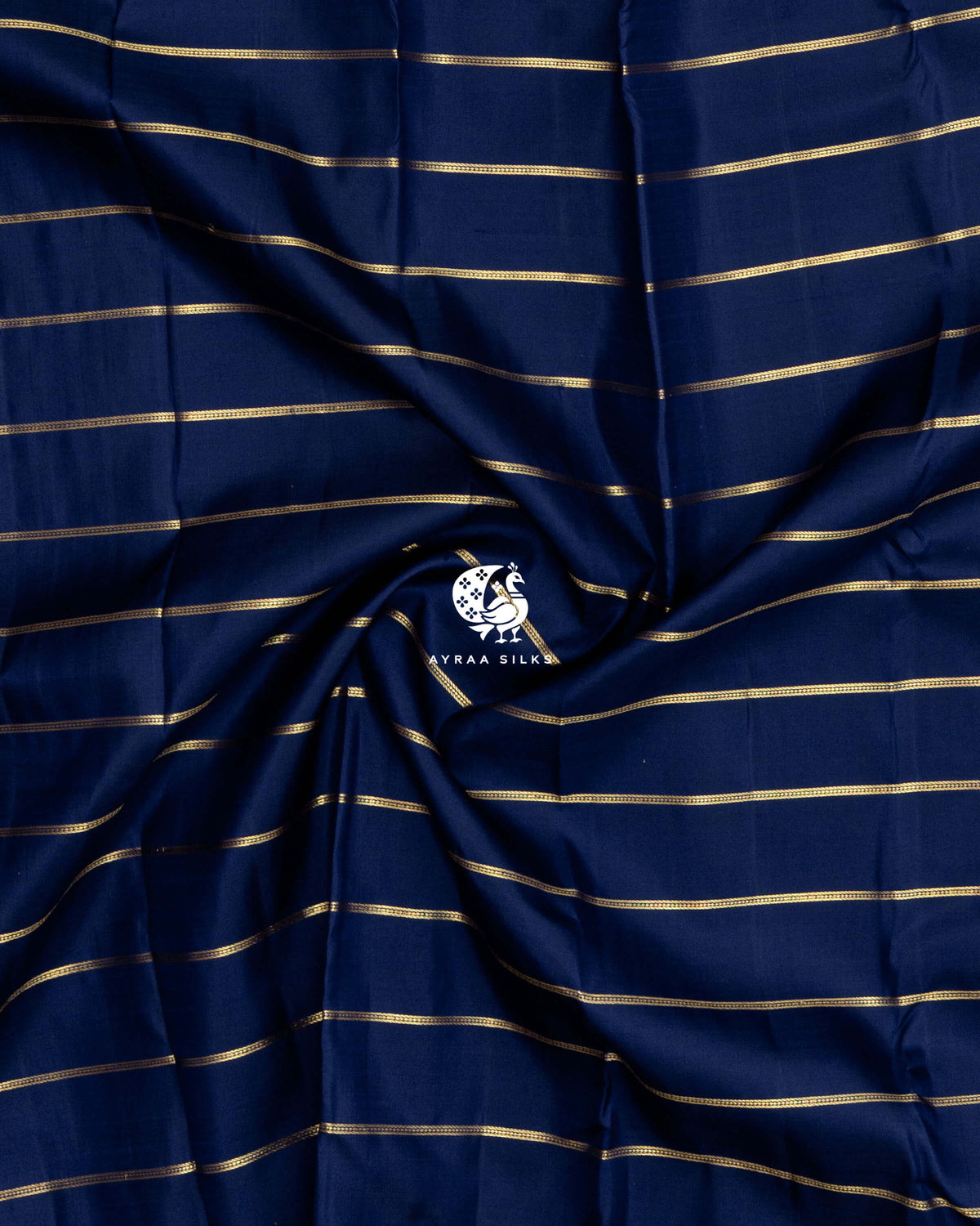 Close-up of the saree body, navy blue silk gathered in soft folds with gold zari stripes