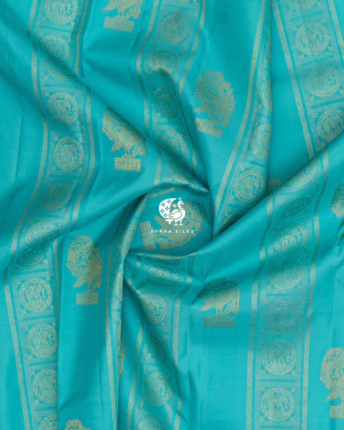 Draped turquoise pure silk saree showing Yaanai (elephant) Chakra medallions and peacock buttas in pure zari