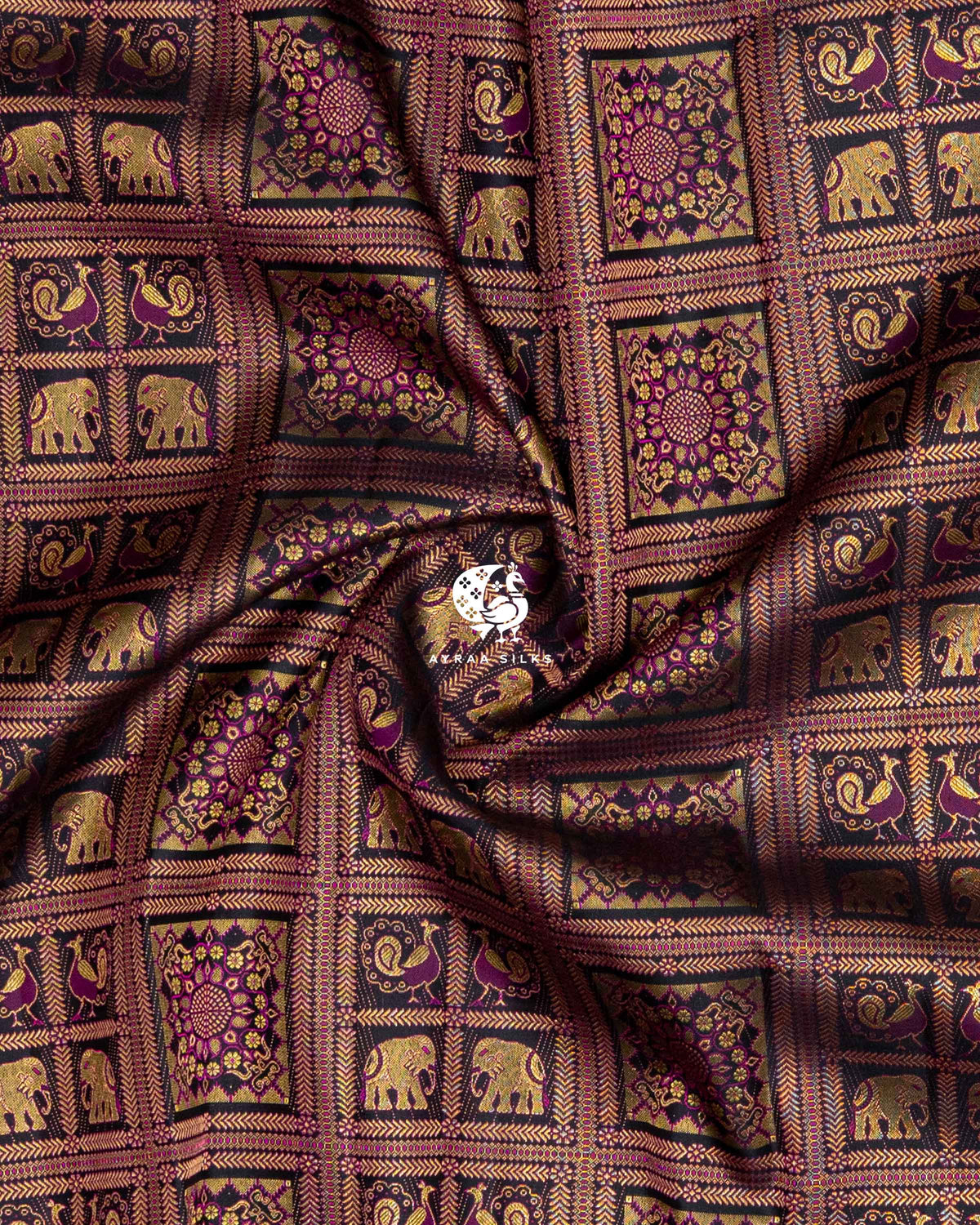 Close-up of the saree body, black and purple zari brocade with elephant and peacock checks gathered in soft folds