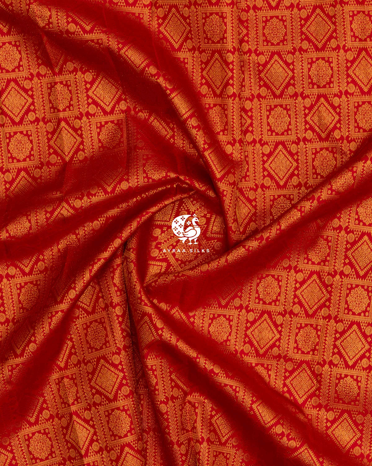 Close-up of the saree body, red pure Kanchipuram silk with all-over zari brocade gathered in soft folds