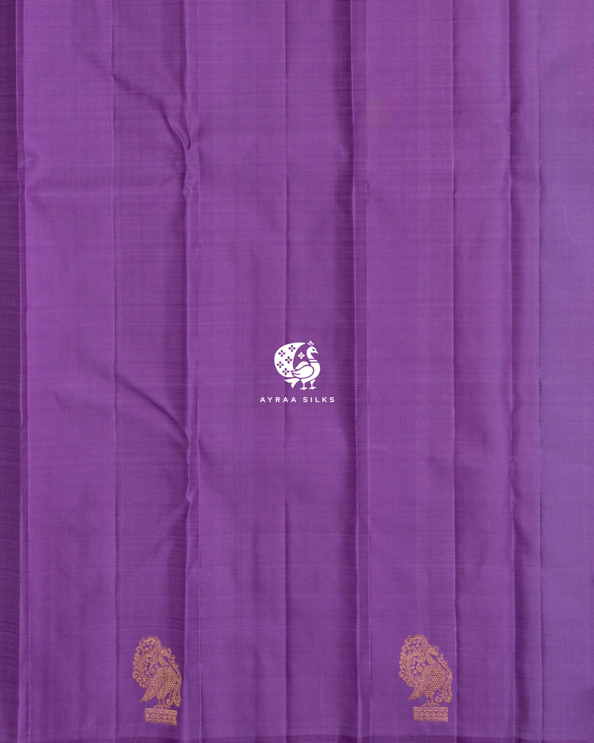 Close view of the running blouse in plain lavender silk with Mayil (peacock) zari buttas