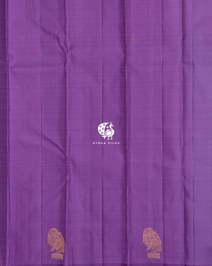 Close view of the running blouse in plain lavender silk with Mayil (peacock) zari buttas